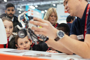 A man looks at computing equipment at Bett – which in 2019 is collaborating with Learnit