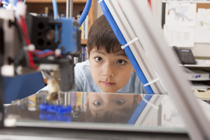 Boy looking at Science Equipment