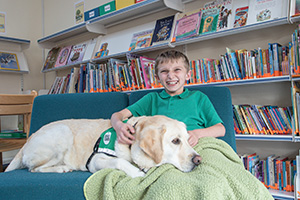 Dogs for Good dog comforting a boy