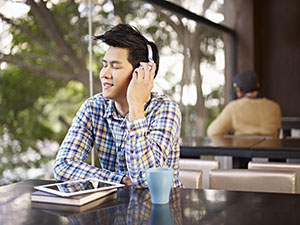 Man with headphones listening to Calibre Audio Library