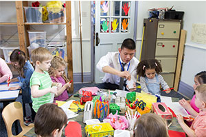 A man teaches in Early Years setting
