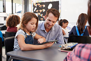 Education professional - teacher - helping a young child