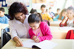 An education professional with young female student