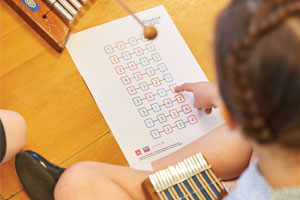 Young girl using classic music resources in classroom