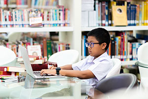Growing your ICT provision effectively - a boy on laptop
