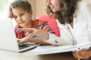 Boy and parent partaking in home education