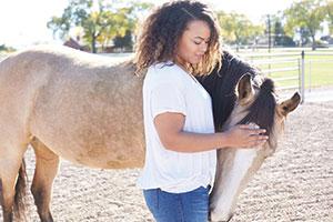 Teenager with horse at Eagala