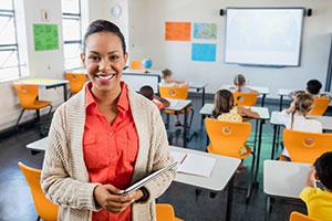 Happy teacher promoting positive mental health & wellbeing at her school