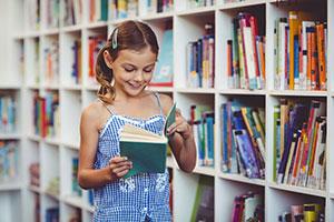 Young girl reading Animal Farm book