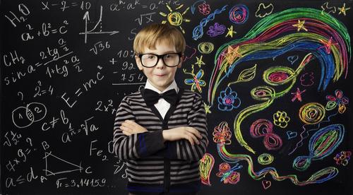 A boy in front of a blackboard
