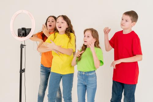 4 children making a TikTok video