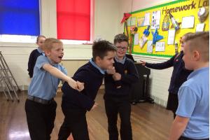 Boys doing a drama class