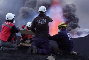 A team of volcanologists at an erupting volcano crater
