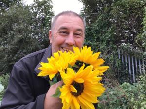Carl Dutton holding some sunflowers