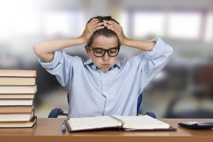A boy stressed out by school work