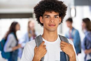 A mixed race boy approximately 16-years-old with afro hair