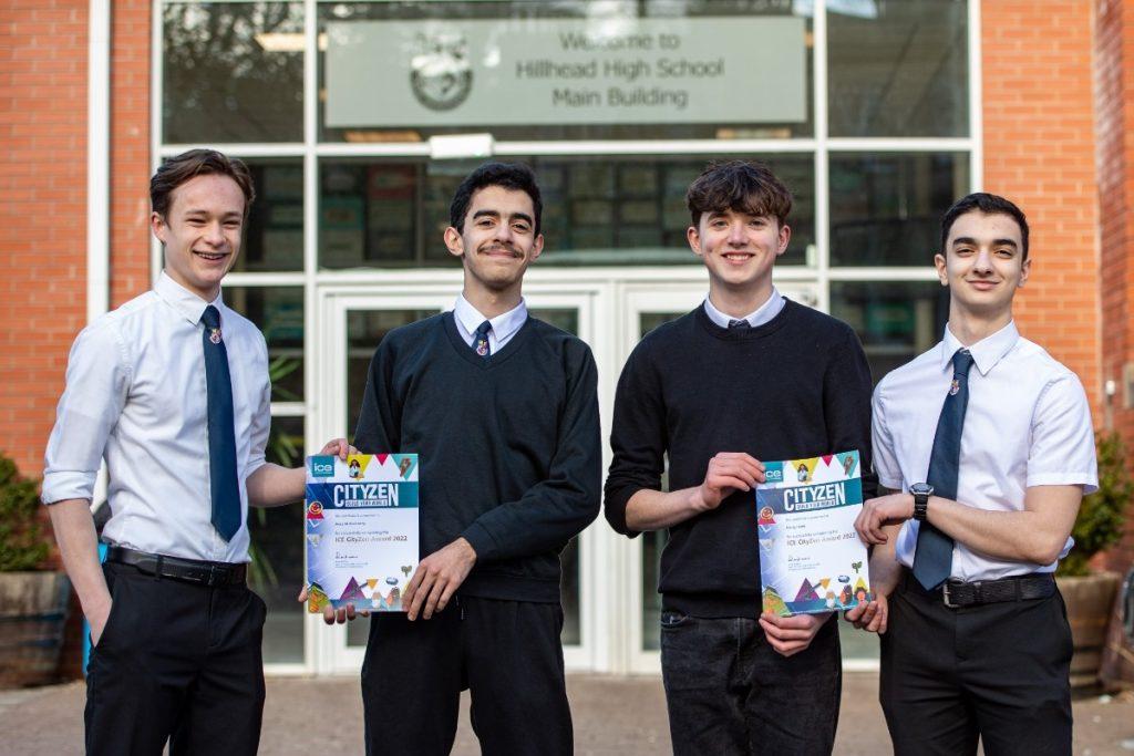 Four boys holding their certificates