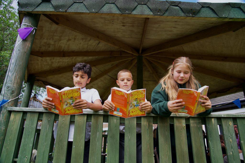 3 children reading books