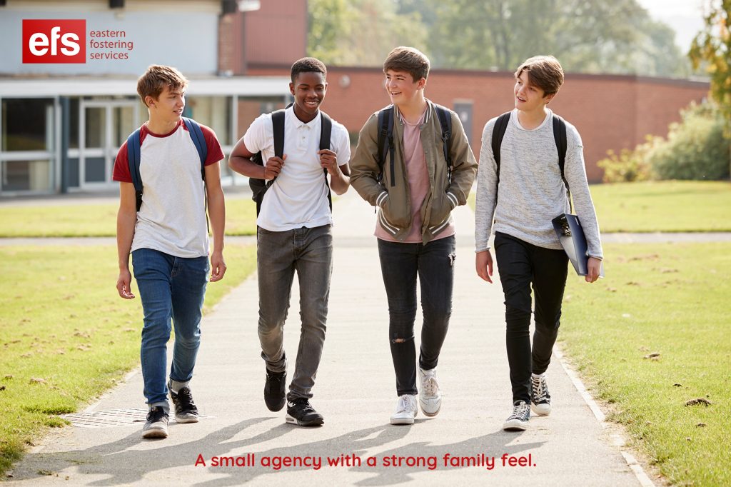 Group Of Male Teenage Students Walking Around College Campus